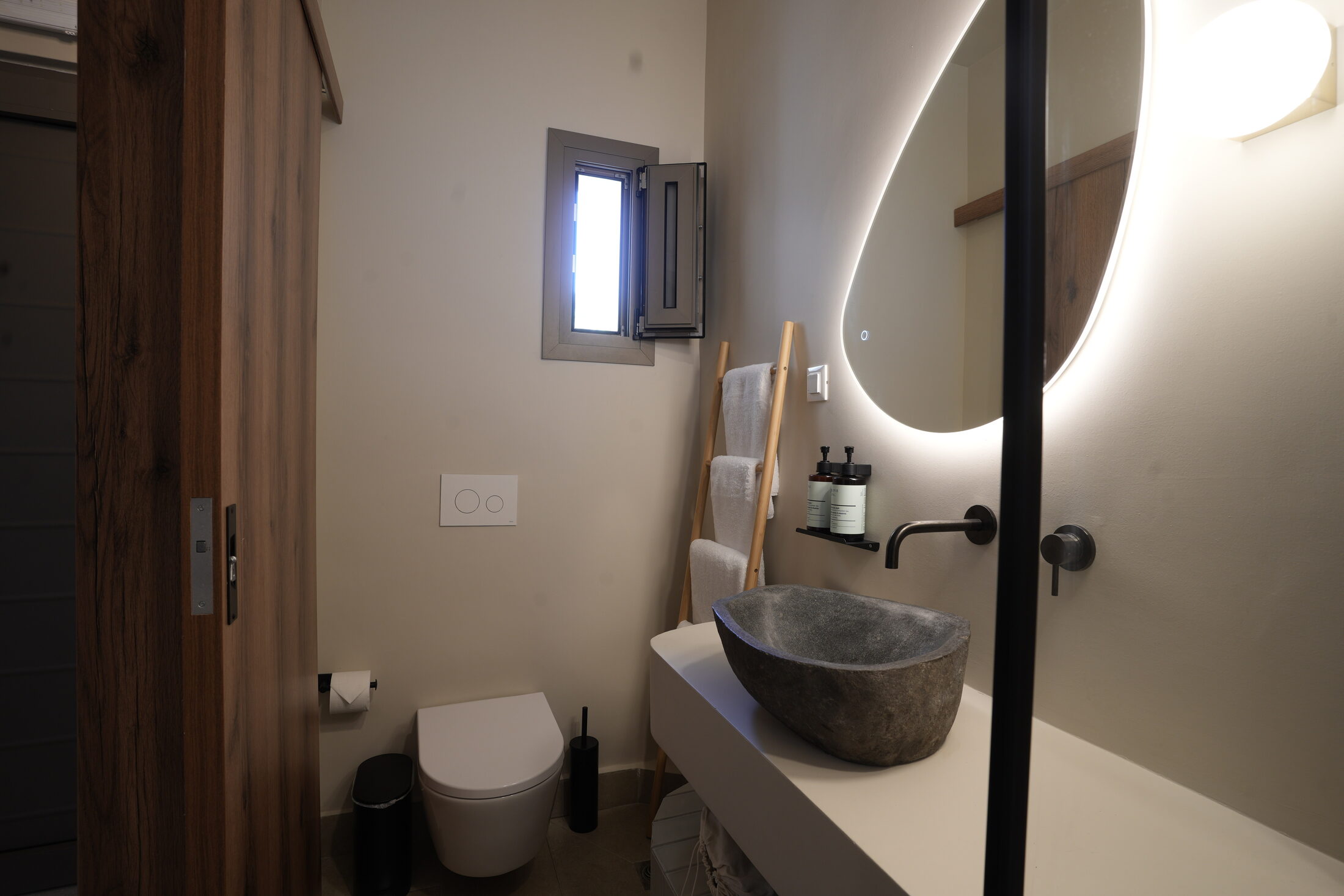 The bath — terrazzo, brass, a walk-in shower